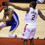 Golden State Warriors guard Quinn Cook, left, passes the ball around Toronto Raptors forward Kawhi Leonard (2) during second-half basketball action in Game 5 of the NBA Finals in Toronto, Monday, June 10, 2019. (Nathan Denette/The Canadian Press via AP)