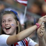 A young supporter waves a US flag prior to the Women's World Cup Group F soccer match between United States and Thailand at the Stade Auguste-Delaune in Reims, France, Tuesday, June 11, 2019. (AP Photo/Alessandra Tarantino)