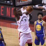 Toronto Raptors center Serge Ibaka (9) dunks as Golden State Warriors forward Jordan Bell (2), Quinn Cook (4) and Klay Thompson look on during second-half basketball action in Game 5 of the NBA Finals in Toronto, Monday, June 10, 2019. (Fank Gunn/The Canadian Press via AP)