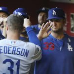 Los Angeles Dodgers' Joc Pederson (31) celebrates with assistant hitting coach Aaron Bates (33) after scoring against the Arizona Diamondbacks during the first inning of a baseball game Monday, June 24, 2019, in Phoenix. (AP Photo/Ross D. Franklin)