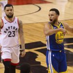 Golden State Warriors' Stephen Curry (30) celebrates in front of Toronto Raptors' Fred VanVleet (23) at the final buzzer as the Warriors defeated the Raptors 106-105 in Game 5 of the NBA Finals in Toronto on Monday June 10, 2019. (Chris Young/The Canadian Press via AP)