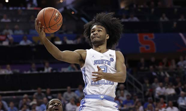 North Carolina's Coby White (2) drives to the basket against Louisville during the first half of an...