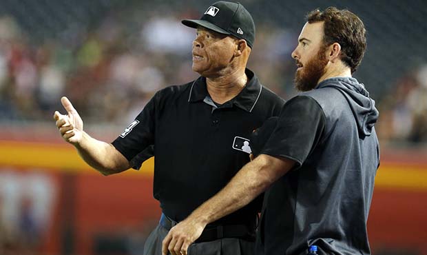 San Francisco Giants' Sam Dyson, right, talks to umpire Kerwin Danley after staring down Arizona Di...