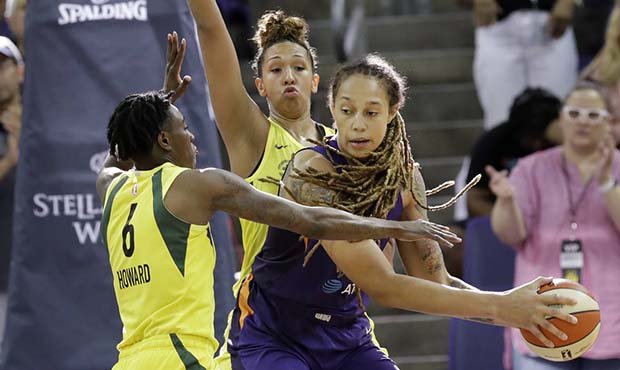 Phoenix Mercury's Brittney Griner, right, is double-teamed by Seattle Storm's Natasha Howard (6) an...