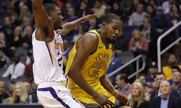 Golden State Warriors forward Kevin Durant (35) is fouled by Phoenix Suns guard Elie Okobo during t...