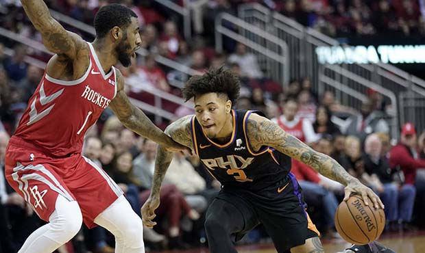 Phoenix Suns' Kelly Oubre Jr. (3) drives toward the basket as Houston Rockets' Iman Shumpert (1) de...