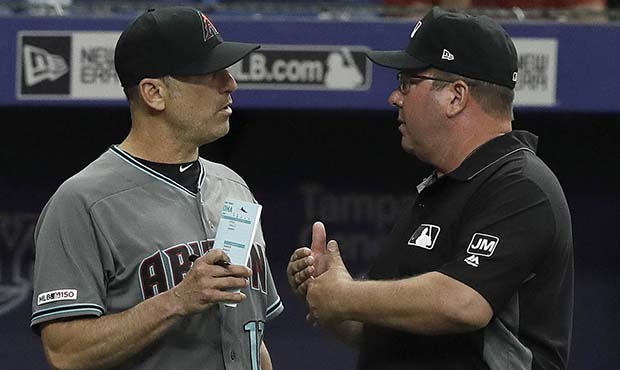 Arizona Diamondbacks manager Torey Lovullo, left, argues with crew chief Sam Holbrook during the si...