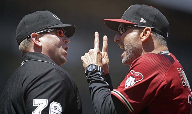 Arizona Diamondbacks manager Torey Lovullo, right, gestures to home plate umpire Mike Muchlinski af...