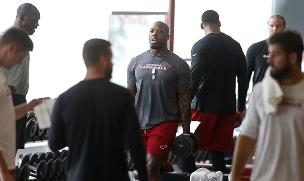 Arizona Cardinals linebacker Terrell Suggs, center, takes part in the team's offseason strength and...