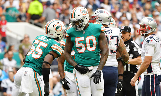 Andre Branch #50 of the Miami Dolphins celebrates a stop in the seocnd half against the New England...