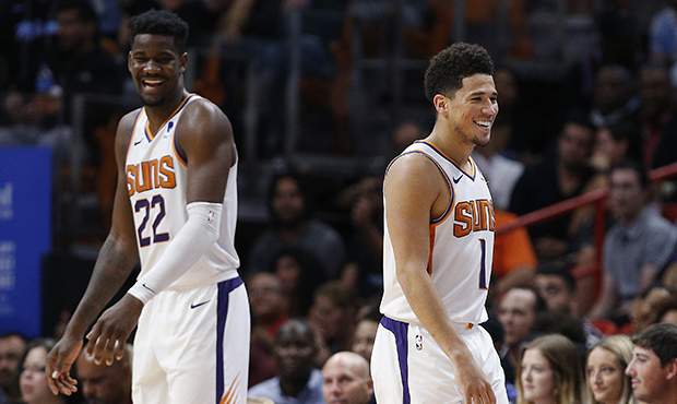 Devin Booker #1 and Deandre Ayton #22 of the Phoenix Suns react against the Miami Heat during the s...