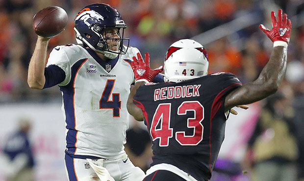 Denver Broncos quarterback Case Keenum (4) throws under pressure from Arizona Cardinals linebacker ...