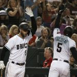 Arizona Diamondbacks' Eduardo Escobar (5) celebrates his home run against the Milwaukee Brewers with Christian Walker during the fourth inning of a baseball game Friday, July 19, 2019, in Phoenix. (AP Photo/Ross D. Franklin)