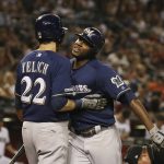 Milwaukee Brewers' Lorenzo Cain, right, celebrates his home run against the Arizona Diamondbacks with Christian Yelich during the third inning of a baseball game Friday, July 19, 2019, in Phoenix. (AP Photo/Ross D. Franklin)