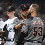 Arizona Diamondbacks manager Torey Lovullo, second from right, holds back Christian Walker (53) after the benches cleared when Walker was hit by a pitch during the eighth inning of a baseball game against the Miami Marlins, Saturday, July 27, 2019, in Miami. (AP Photo/Wilfredo Lee)
