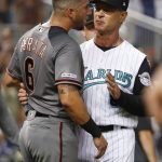 Miami Marlins manager Don Mattingly, right, holds back Arizona Diamondbacks' David Peralta (6) when the benches cleared after Diamondbacks' Christian Walker was hit by a pitch during the eighth inning of a baseball game, Saturday, July 27, 2019, in Miami. (AP Photo/Wilfredo Lee)