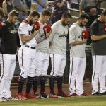 Arizona Diamondbacks players pause during a moment of silence for Los Angeles Angels pitcher Tyler Skaggs prior to a baseball game against the Colorado Rockies, Friday, July 5, 2019, in Phoenix. Skaggs, a former Diamondbacks player, unexpectedly passed away earlier in the week while on a road trip with the Angels in Texas. (AP Photo/Ross D. Franklin)