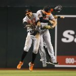 Baltimore Orioles' Anthony Santander, left, Trey Mancini, right, and Stevie Wilkerson, back right, celebrate a 7-2 win against the Arizona Diamondbacks after a baseball game, Tuesday, July 23, 2019, in Phoenix. (AP Photo/Ross D. Franklin)