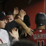 Arizona Diamondbacks' Ketel Marte, right, celebrates his run scored against the Milwaukee Brewers with teammates during the first inning of a baseball game Sunday, July 21, 2019, in Phoenix. (AP Photo/Ross D. Franklin)