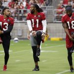 Arizona Cardinals wide receivers Christian Kirk (13), Larry Fitzgerald (11) and Kevin White (18) stretch out during NFL football practice at State Farm Stadium, Friday, July 26, 2019, in Glendale, Ariz. (AP Photo/Ross D. Franklin)