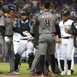 Players confront each other after the benches cleared when Arizona Diamondbacks' Christian Walker was hit by a pitch during the eighth inning of a baseball game against the Miami Marlins, Saturday, July 27, 2019, in Miami. The Diamondbacks defeated the Marlins 9-2. (AP Photo/Wilfredo Lee)