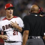 Arizona Diamondbacks starting pitcher Zack Greinke (21) argues with umpire CB Bucknor, right, after being called for interference during the third inning of a baseball game against the Colorado Rockies, Friday, July 5, 2019, in Phoenix. (AP Photo/Ross D. Franklin)