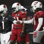 Arizona Cardinals quarterback Kyler Murray (1) gets a fist bump from Cardinals wide receiver Larry Fitzgerald, right, after the two connected on a pass completion during NFL football practice at State Farm Stadium Friday, July 26, 2019, in Glendale, Ariz. (AP Photo/Ross D. Franklin)