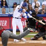 Los Angeles Dodgers' Cody Bellinger hits a solo home run off Arizona Diamondbacks starting pitcher Merrill Kelly, foreground, during the second inning of a baseball game Wednesday, July 3, 2019, in Los Angeles. (AP Photo/Mark J. Terrill)