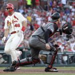 St. Louis Cardinals' Paul Goldschmidt (46) scores past Arizona Diamondbacks catcher Carson Kelly during the first inning of a baseball game Saturday, July 13, 2019, in St. Louis. (AP Photo/Jeff Roberson)