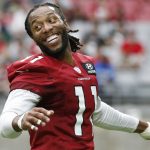 Arizona Cardinals wide receiver Larry Fitzgerald smiles as he talks with teammates as they stretch during NFL football practice at State Farm Stadium Friday, July 26, 2019, in Glendale, Ariz. (AP Photo/Ross D. Franklin)