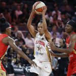 Washington Mystics' Kristi Toliver, of Team Delle Donne, drives between Chicago Sky's Diamond DeShields, of Team Wilson, left, and Indiana Fever's Erica Wheeler during the first half of a WNBA All-Star game Saturday, July 27, 2019, in Las Vegas. (AP Photo/John Locher)