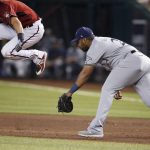 Milwaukee Brewers first baseman Jesus Aguilar, right, is unable to get to a ground ball as Arizona Diamondbacks' Nick Ahmed, left, leaps over the ball during the sixth inning of a baseball game Sunday, July 21, 2019, in Phoenix. Diamondbacks' Ahmed was forced out at second base on the play. (AP Photo/Ross D. Franklin)
