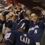 Milwaukee Brewers' Ryan Braun (8) joins teammates in celebrating a home run by Lorenzo Cain, front, against the Arizona Diamondbacks during the third inning of a baseball game Friday, July 19, 2019, in Phoenix. (AP Photo/Ross D. Franklin)