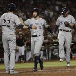 Milwaukee Brewers' Ryan Braun (8) celebrates with Christian Yelich (22) and Mike Moustakas after Moustakas hit a three-run home run against the Arizona Diamondbacks during the eighth inning of a baseball game, Saturday, July 20, 2019, in Phoenix. (AP Photo/Matt York)