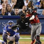 Arizona Diamondbacks' Christian Walker hits a two-run home run as Los Angeles Dodgers catcher Austin Barnes, left, and home plate umpire Vic Carapazza watch during the fourth inning of a baseball game Wednesday, July 3, 2019, in Los Angeles. (AP Photo/Mark J. Terrill)