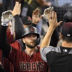 Arizona Diamondbacks' Christian Walker is congratulated by teammates after hitting a two-run home run during the fourth inning of a baseball game against the Los Angeles Dodgers on Wednesday, July 3, 2019, in Los Angeles. (AP Photo/Mark J. Terrill)