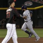 Milwaukee Brewers Eric Thames rounds the bases after hitting a solo home run off Arizona Diamondbacks starting pitcher Zack Greinke (21) during the sixth inning of a baseball game, Saturday, July 20, 2019, in Phoenix. (AP Photo/Matt York)