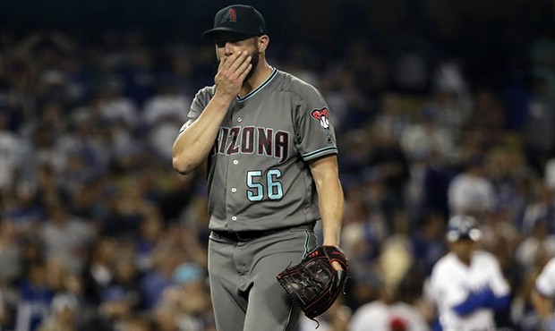 Arizona Diamondbacks relief pitcher Greg Holland walks off the mound after being pulled from the ga...