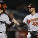 Baltimore Orioles relief pitcher Shawn Armstrong (43) celebrates a 7-2 win as he acknowledges catcher Chance Sisco after a baseball game against the Arizona Diamondbacks, Tuesday, July 23, 2019, in Phoenix. (AP Photo/Ross D. Franklin)