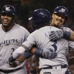 Milwaukee Brewers' Tyler Saladino celebrates his grand slam against the Arizona Diamondbacks with Brewers' Orlando Arcia (3) and Jesus Aguilar, left, during the fourth inning of a baseball game Sunday, July 21, 2019, in Phoenix. (AP Photo/Ross D. Franklin)