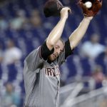 Arizona Diamondbacks starting pitcher Merrill Kelly wipes his face during the fifth inning of a baseball game against the Miami Marlins, Monday, July 29, 2019, in Miami. (AP Photo/Lynne Sladky)