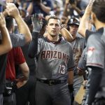 Arizona Diamondbacks' Nick Ahmed (13) is congratulated by teammates after he hit a grand slam home run scoring Eduardo Escobar, Christian Walker and Jake Lamb during the fourth inning of a baseball game against the Miami Marlins, Saturday, July 27, 2019, in Miami. (AP Photo/Wilfredo Lee)