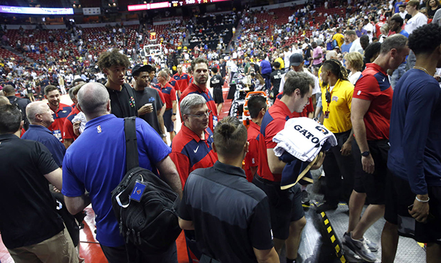 Players and staff leave the court after an earthquake during an NBA summer league basketball game b...