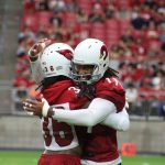Arizona Cardinals WR Larry Fitzgerald (11) and safety D.J. Swearinger (36) greet each other during training camp on Thursday, July 25, 2019 at State Farm Stadium in Glendale, Ariz. (Photo: Logan Newman/98.7 Arizona Sports)