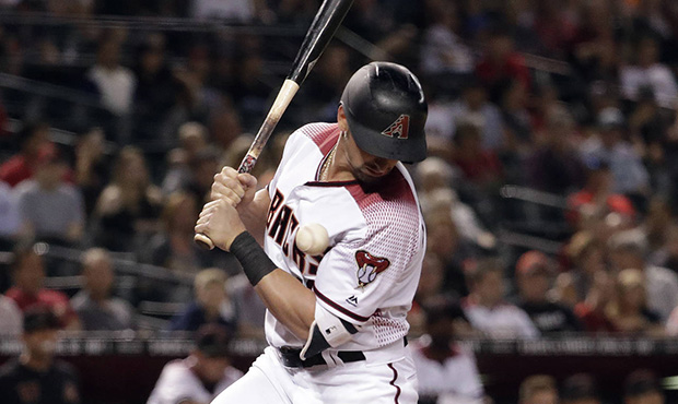 Arizona Diamondbacks' Tim Locastro gets hit by a Texas Rangers pitch during the second inning of a ...