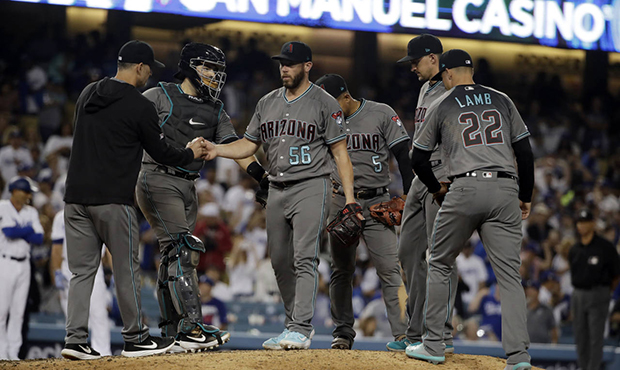 Arizona Diamondbacks relief pitcher Greg Holland (56) is pulled from the game by manager Torey Lovu...