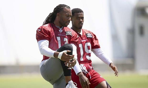 Arizona Cardinals wide receiver Larry Fitzgerald, left, stretches out with wide receiver KeeSean Jo...