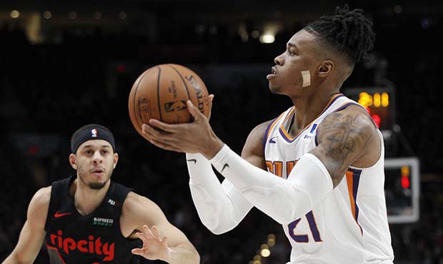 Phoenix Suns forward Richaun Holmes, right, shoots as Portland Trail Blazers guard Seth Curry, left...