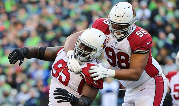 Rodney Gunter #95 and Corey Peters #98 of the Arizona Cardinals celebrate a defensive stop in the t...