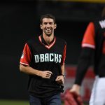 Olympic gold metalist swimmer Michael Phelps walks off the mound after throwing out the ceremonial first pitch prior to a game between the Arizona Diamondbacks and the Seattle Mariners. All players across MLB will wear nicknames on their backs as well as colorful, non-traditional uniforms featuring alternate designs inspired by youth-league uniforms during Players Weekend.  (Photo by Norm Hall/Getty Images)